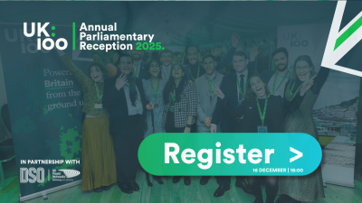 UK100 Annual Parliamentary Reception 2025 event banner. Background shows group photo of attendees from previous reception wearing green lanyards and professional attire, standing in front of UK100 branded backdrop with text "Power Britain from the ground up". UK100 logo in white appears top left. Text reads "Annual Parliamentary Reception 2025" in white and green. Bottom left shows "In partnership with DSO UK Forum". Large turquoise button on right displays "Register >" with date "16 December | 18:00".