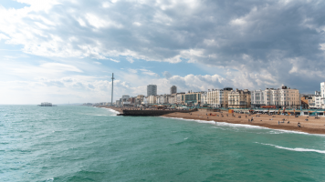 View across to Brighton beach from the sea on a sunny, partly-cloudy day