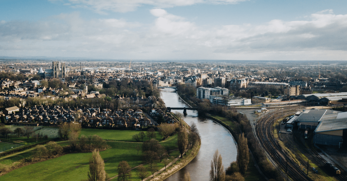 Aerial view of the River Ouse running through York on partly-cloudy day
